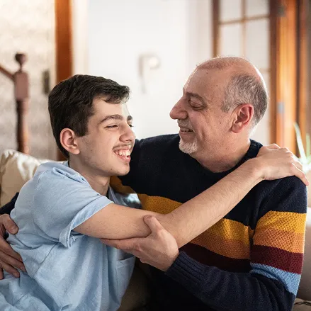 Father and son hugging each other at home