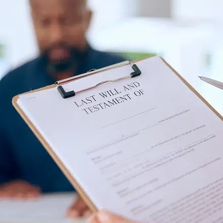 Hand, document or testament in office by closeup for last will, insurance of funeral planning for family future. Safety, security or protection of married couple in home for preparation of health